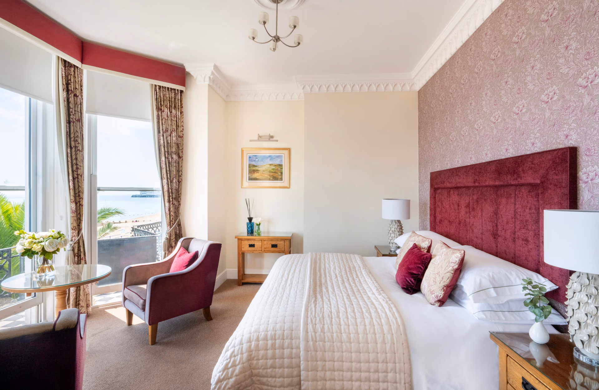 Sea View Junior Deluxe Room with freshly made bed, two chairs and table
